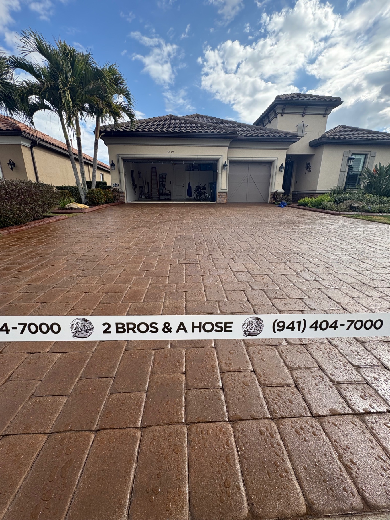 Freshly sealed paver driveway at an Esplanade Golf & Country Club home with 2 Bros & A Hose tape