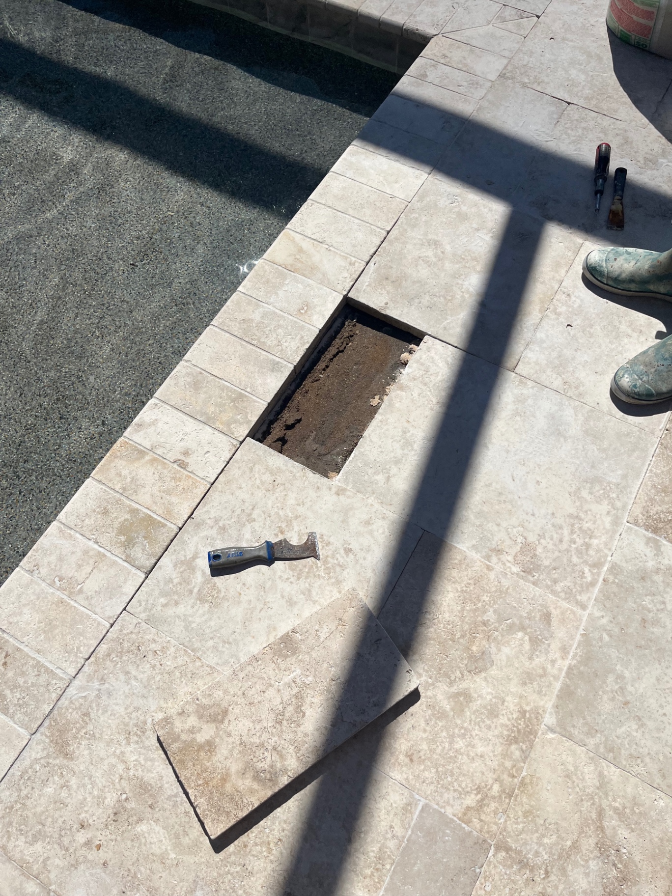 Travertine pool deck tile repair at an Azario Esplanade home