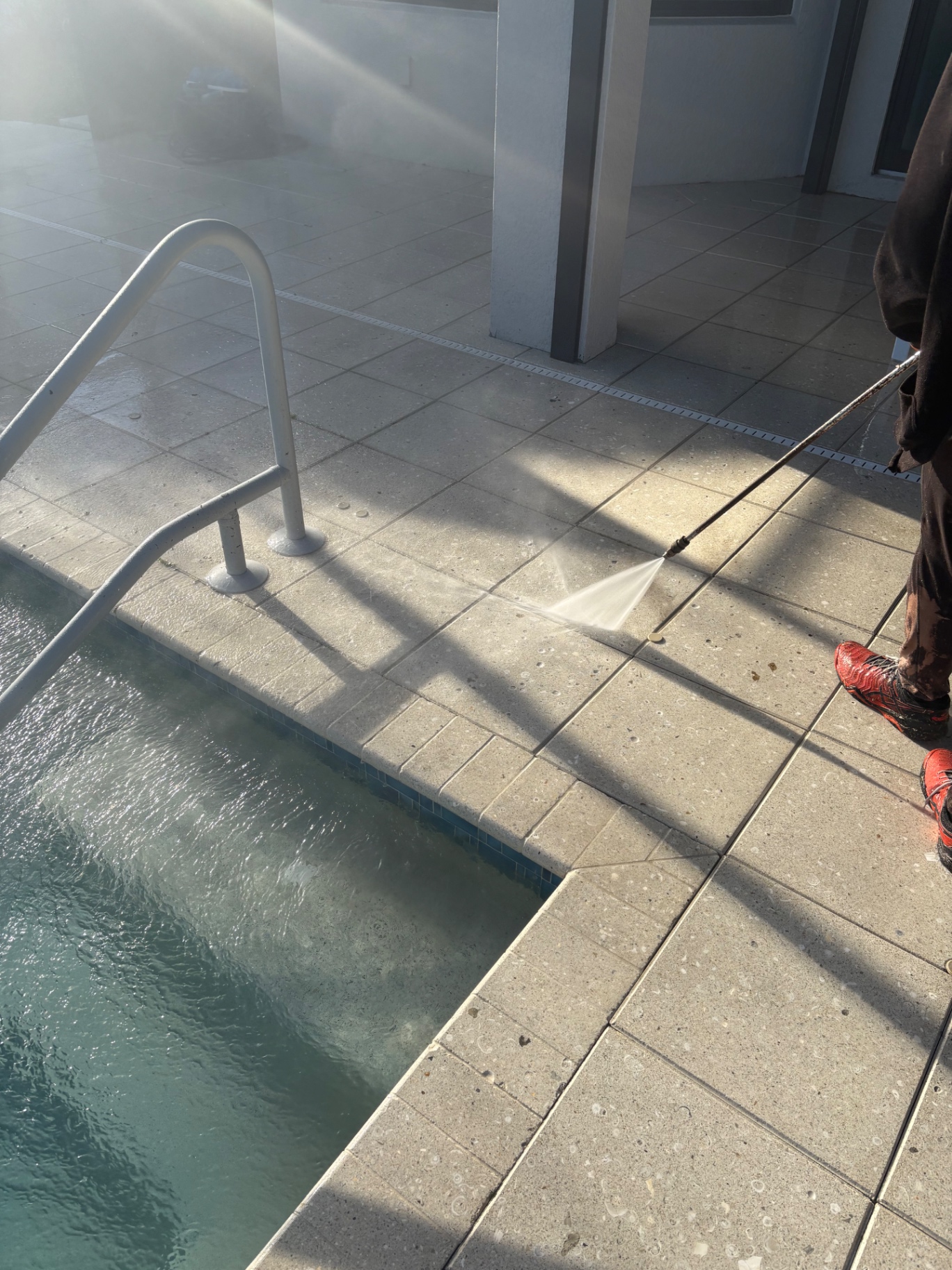 Pool deck surface cleaning in progress at an Azario Esplanade home