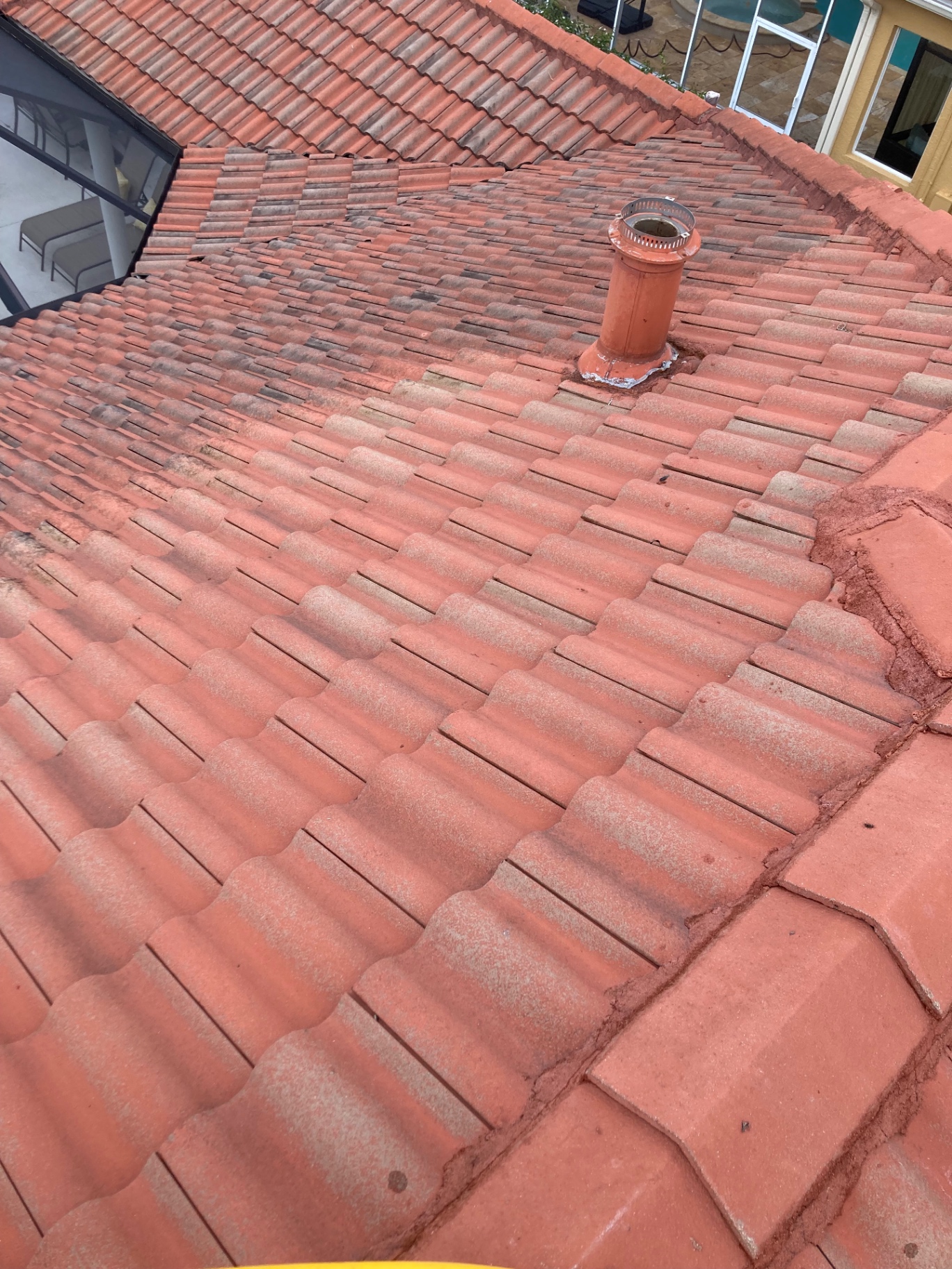 Tile roof cleaning in progress at a Tara Golf & Country Club home with visible shaded sections