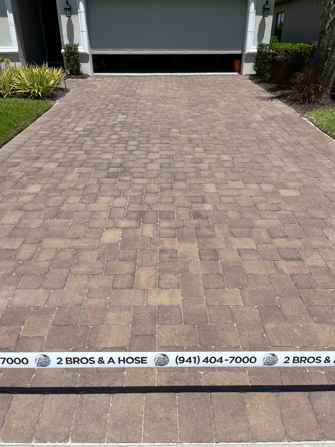 Finished paver driveway with 2 Bros & A Hose tape at an Azario Esplanade home