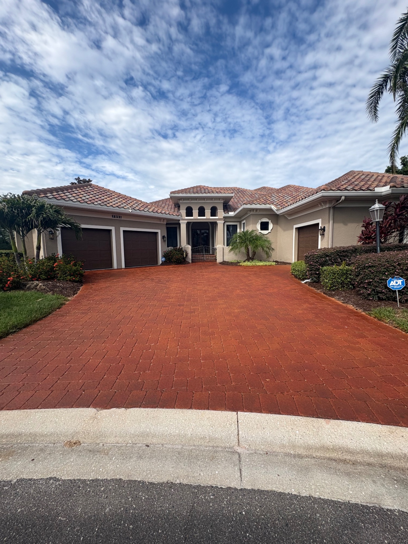 Mediterranean home with freshly sealed red paver driveway in Lakewood Ranch Country Club